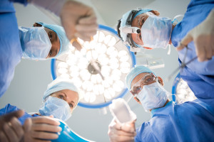 Surgeons team at work in operating room. Below view of surgeons